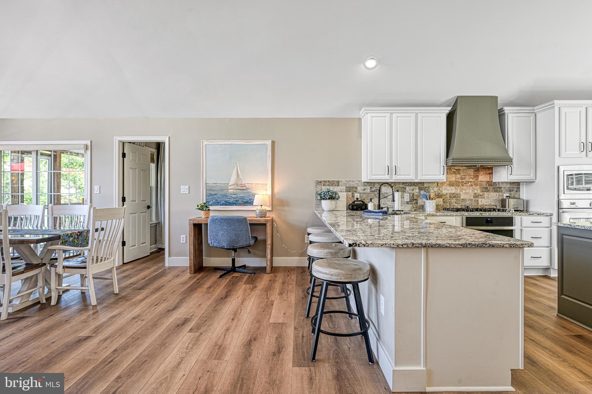 1069 Mitchell Point Road Mineral, VA 23117 - Photo 33 of 110 a kitchen with stainless steel appliances granite countertop a stove a sink dishwasher and a refrigerator with wooden floor
