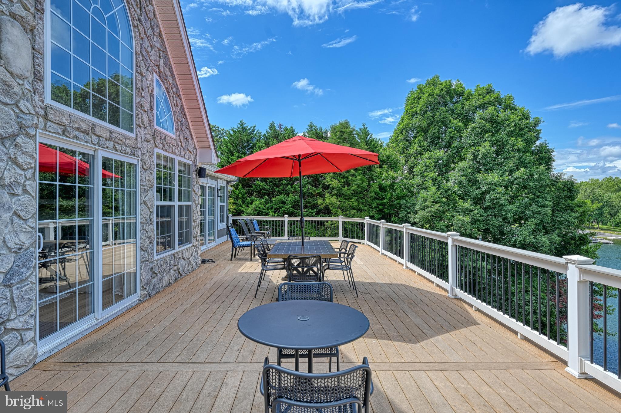 1069 Mitchell Point Road Mineral, VA 23117 - Photo 76 of 110 a view of a patio with a table chairs and a fire pit