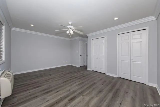 a view of an empty room with wooden floor