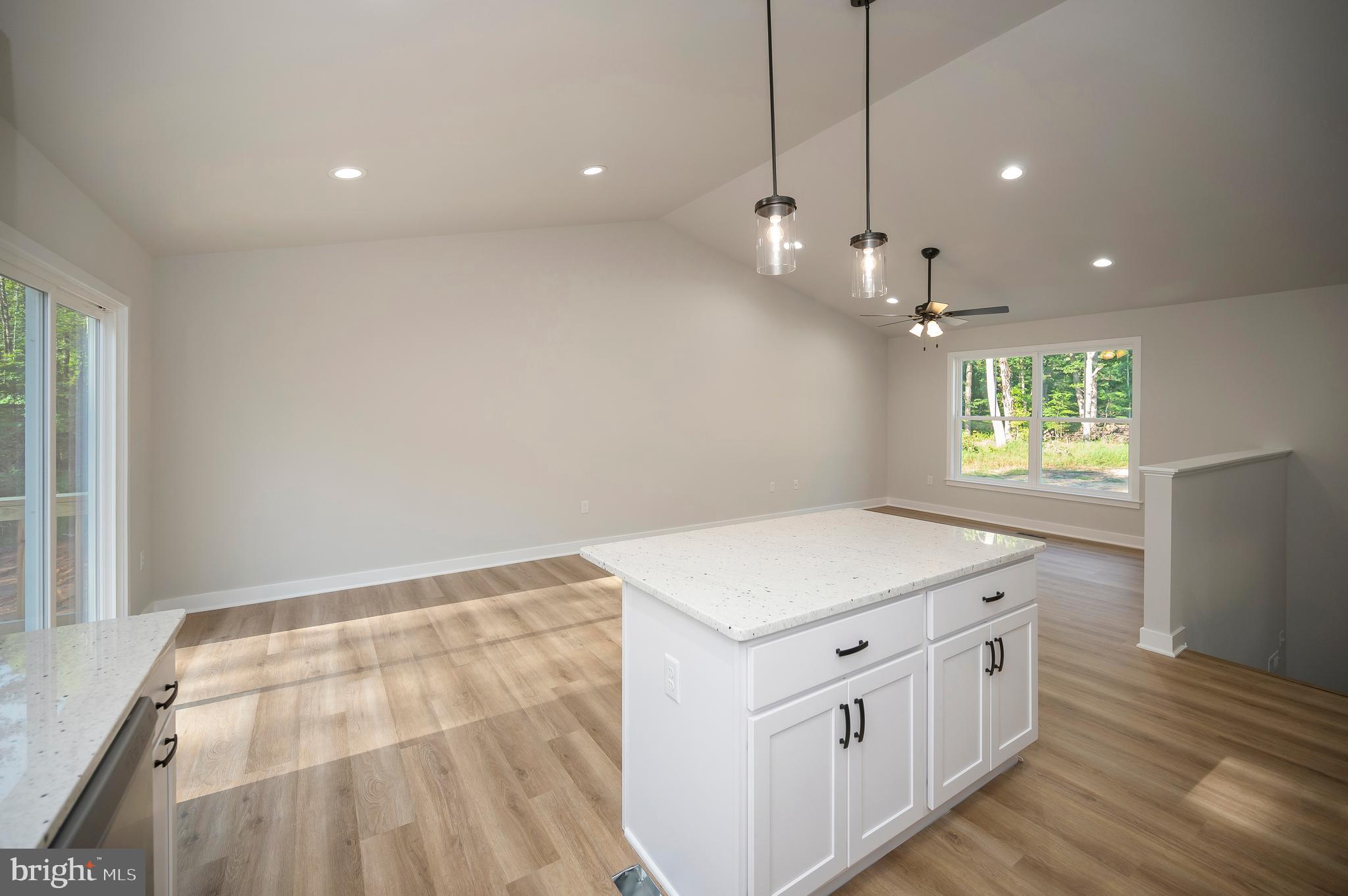 3153 Lewiston Road Bumpass, VA 23024 - Photo 15 of 45 a kitchen that has a lot of white cabinets and wooden floor