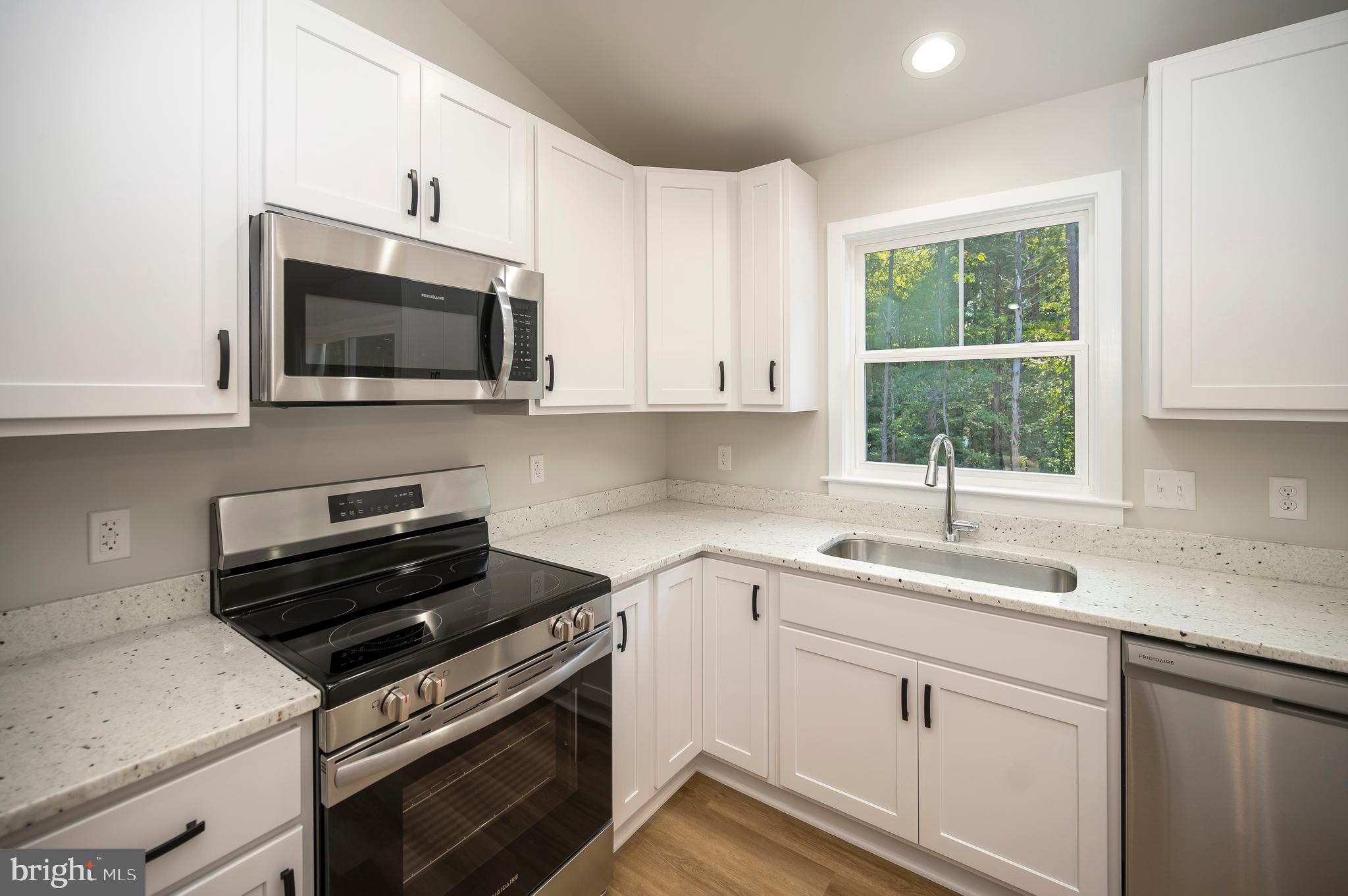 3153 Lewiston Road Bumpass, VA 23024 - Photo 18 of 45 a kitchen with a sink stove and microwave