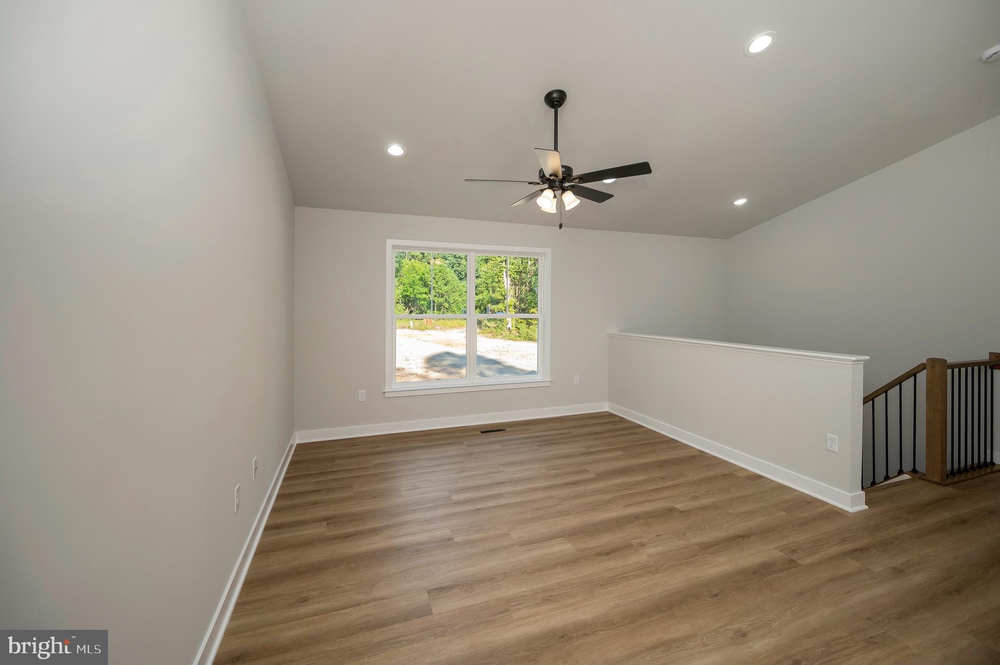 3153 Lewiston Road Bumpass, VA 23024 - Photo 21 of 45 a view of an empty room with a window and wooden floor