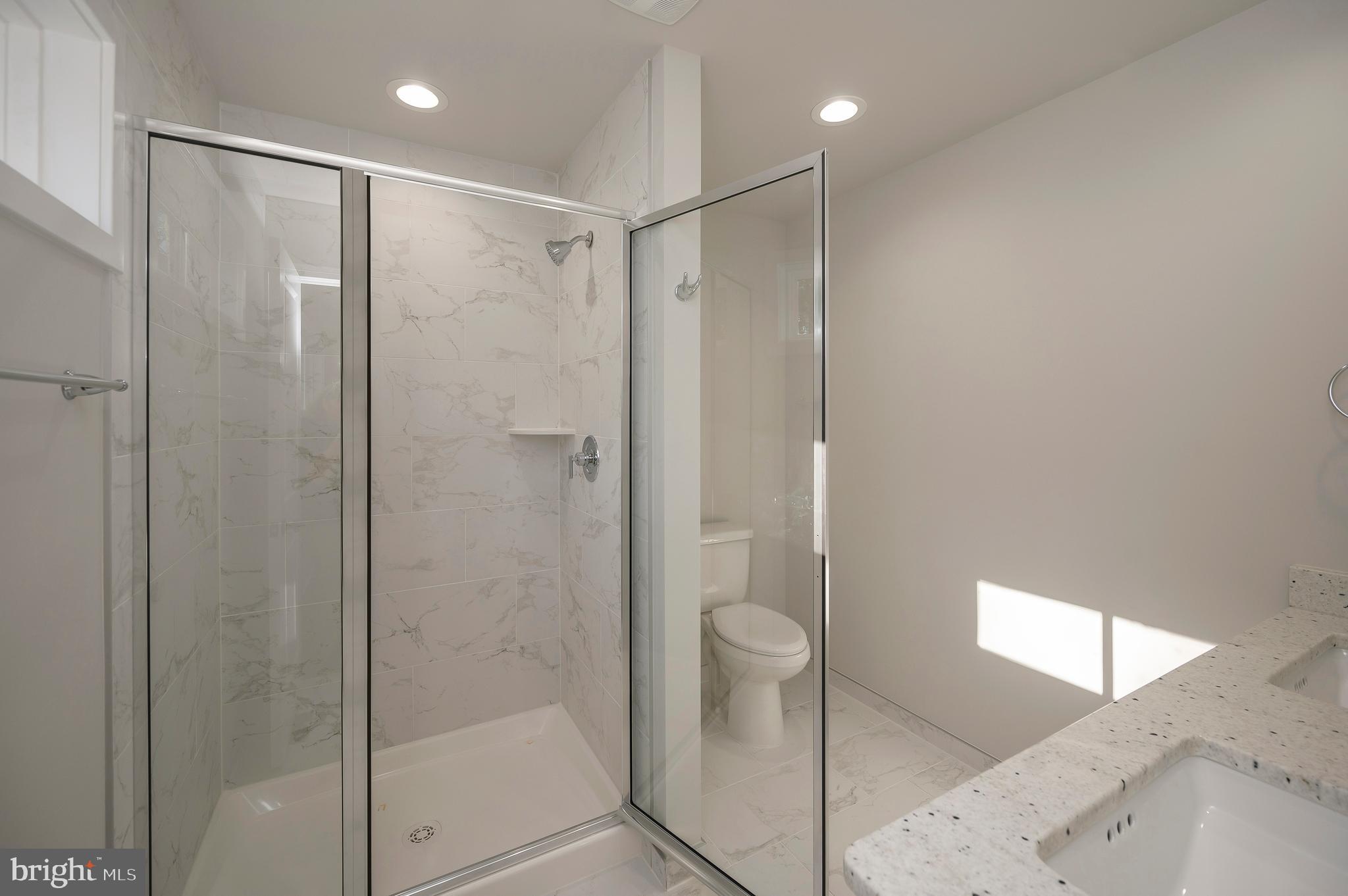 3153 Lewiston Road Bumpass, VA 23024 - Photo 24 of 45 a bathroom with a shower and a glass door