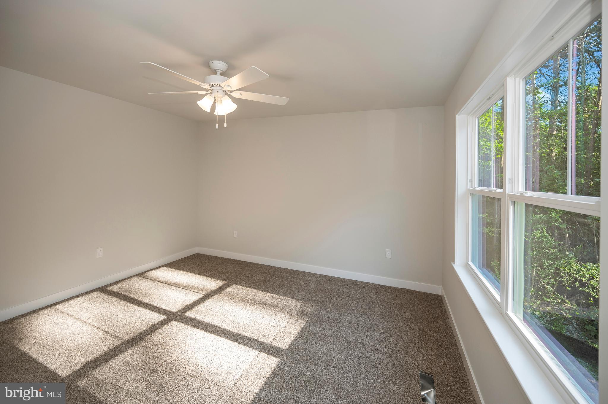 3153 Lewiston Road Bumpass, VA 23024 - Photo 25 of 45 an empty room with windows and fan