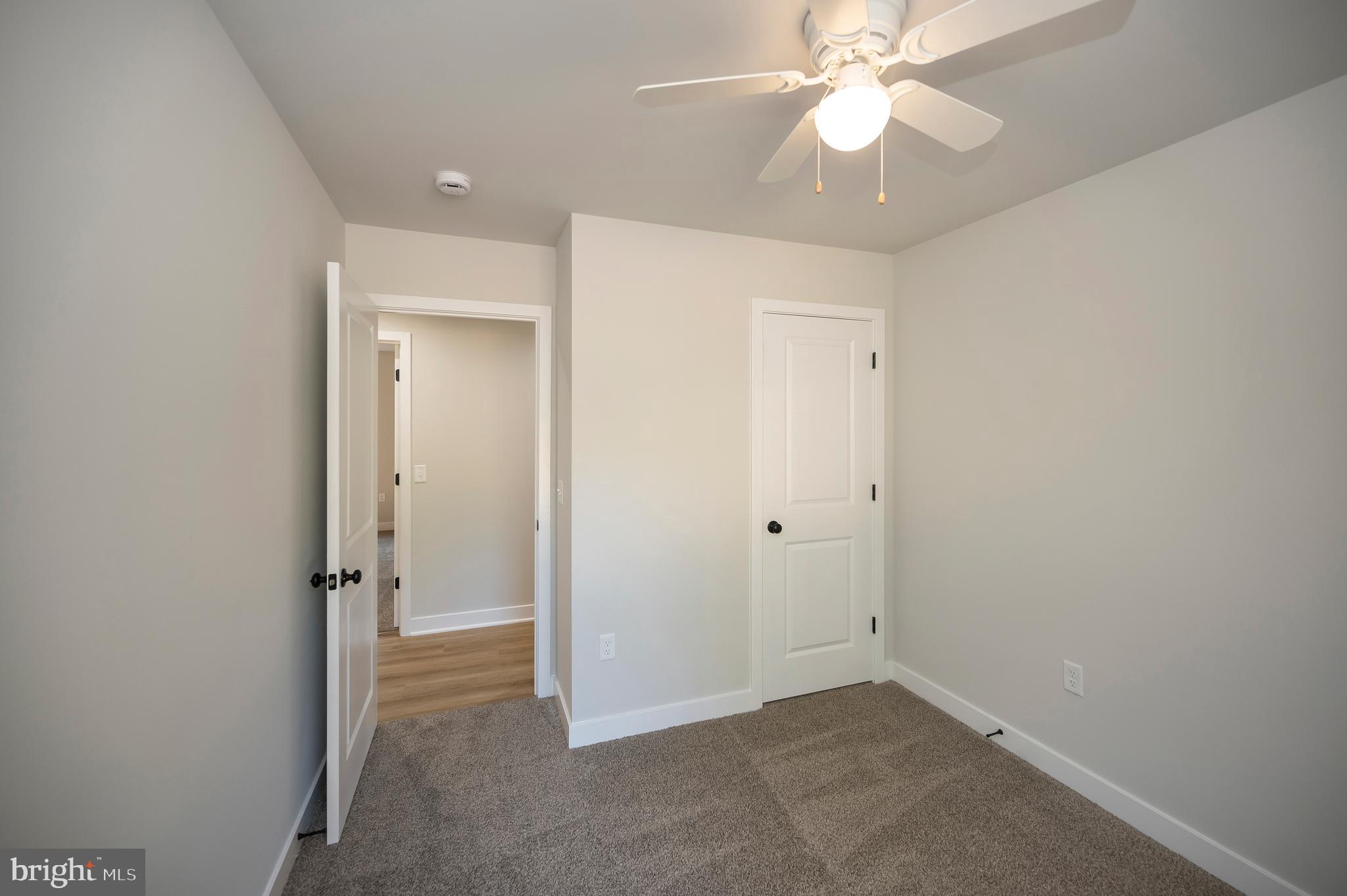 3153 Lewiston Road Bumpass, VA 23024 - Photo 29 of 45 an empty room with closet and a chandelier fan