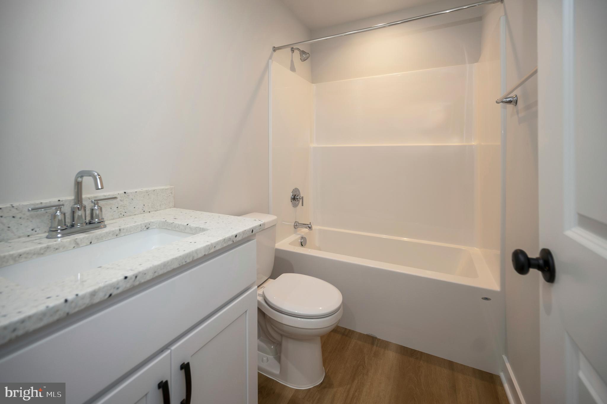 3153 Lewiston Road Bumpass, VA 23024 - Photo 30 of 45 a bathroom with a sink a toilet and shower