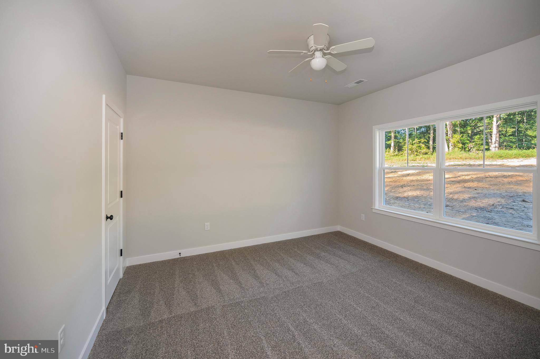 3153 Lewiston Road Bumpass, VA 23024 - Photo 36 of 45 an empty room with windows and ceiling fan