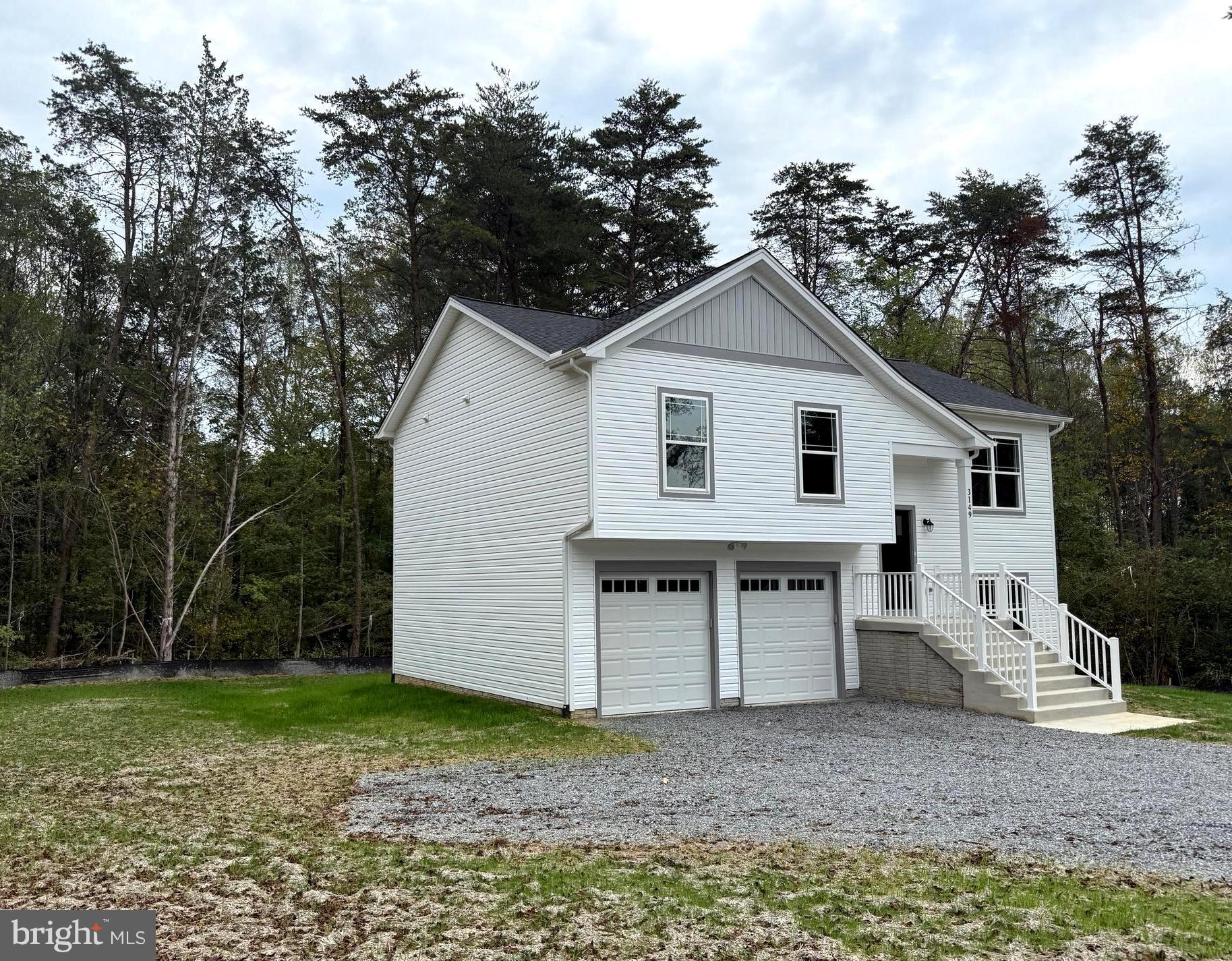 3153 Lewiston Road Bumpass, VA 23024 - Photo 44 of 45 a view of a white house with a yard and large tree