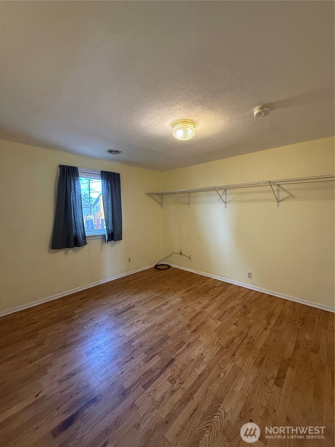 306 South Adams Street Waterville, WA 98858 - Photo 16 of 25 an empty room with wooden floor and windows
