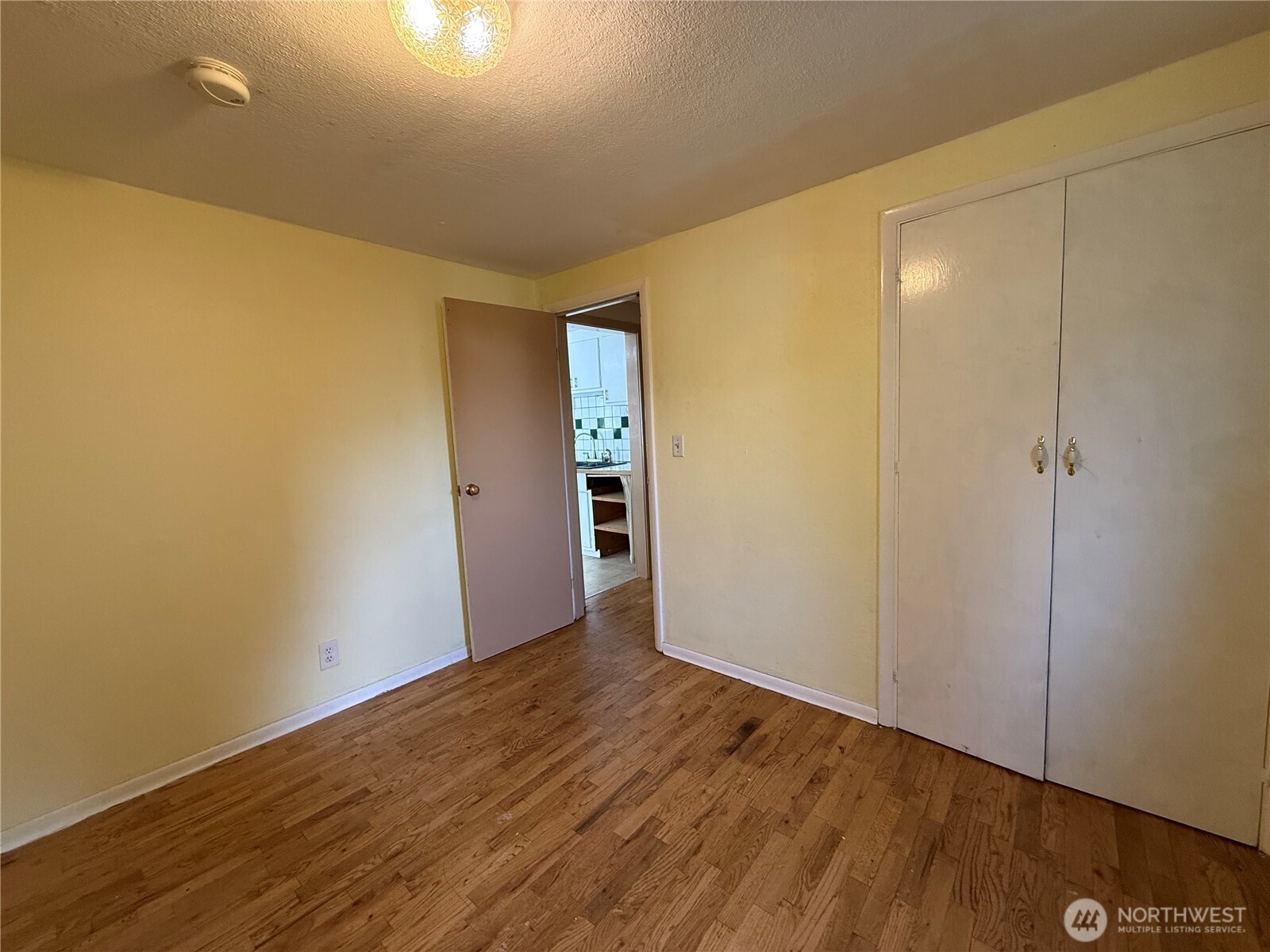 306 South Adams Street Waterville, WA 98858 - Photo 18 of 25 a view of an empty room with wooden floor and closet