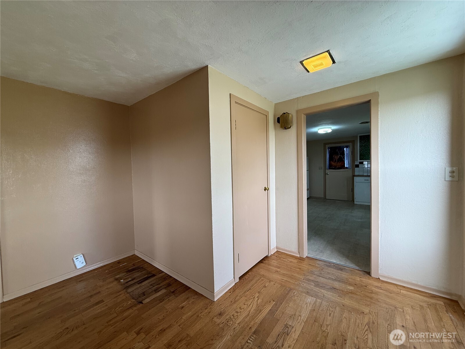 306 South Adams Street Waterville, WA 98858 - Photo 19 of 25 a view of an empty room with wooden floor and closet
