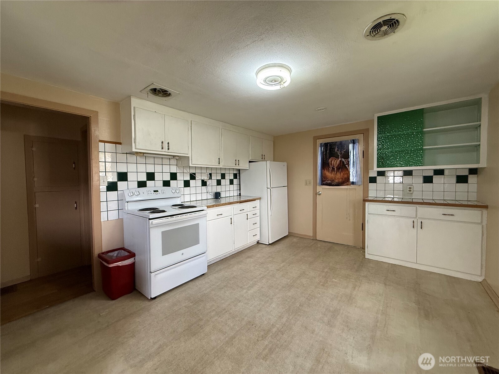 306 South Adams Street Waterville, WA 98858 - Photo 6 of 25 a kitchen with white cabinets and white appliances