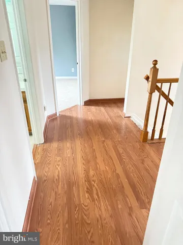 a view of a room with wooden floor and staircase