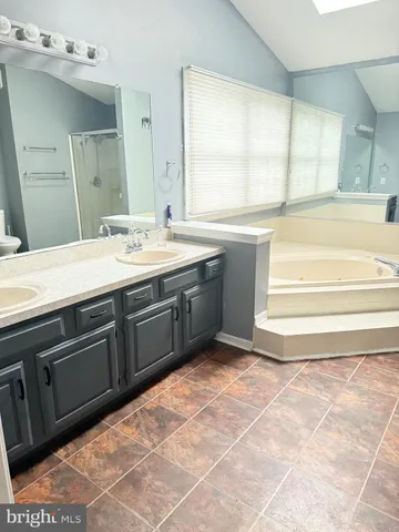 a bathroom with a bathtub and shower