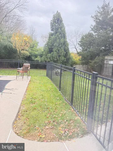a view of a swimming pool with a patio and yard