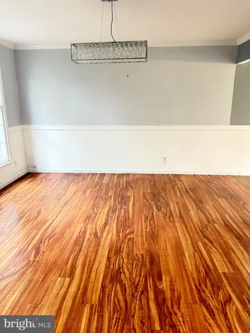 a view of a room with wooden floor and fence