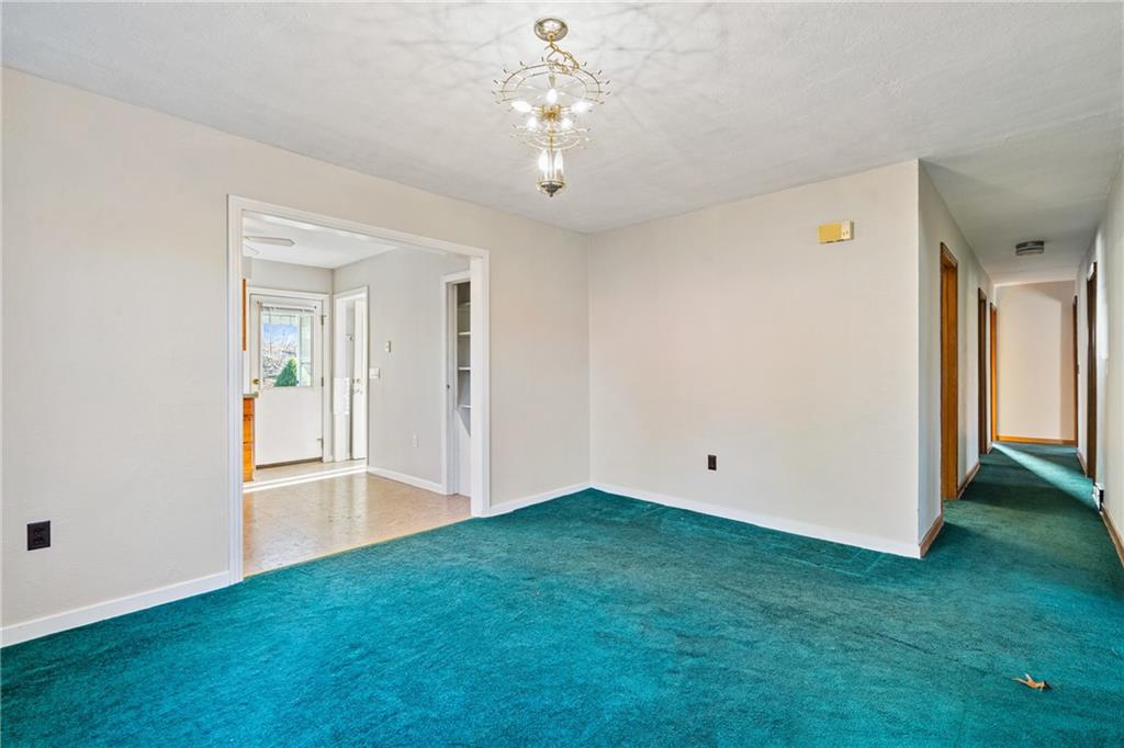 223 Oak Road Pittsburgh, PA 15239 - Photo 7 of 25 a view of an empty room with window and wooden floor