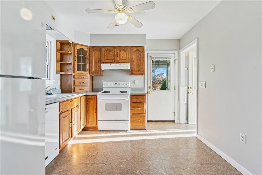 223 Oak Road Pittsburgh, PA 15239 - Photo 8 of 25 a kitchen with stainless steel appliances granite countertop a stove a sink and a refrigerator