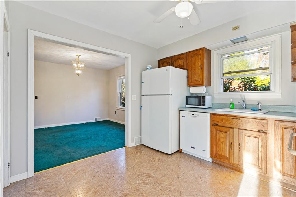 223 Oak Road Pittsburgh, PA 15239 - Photo 10 of 25 a kitchen with a refrigerator sink and cabinets