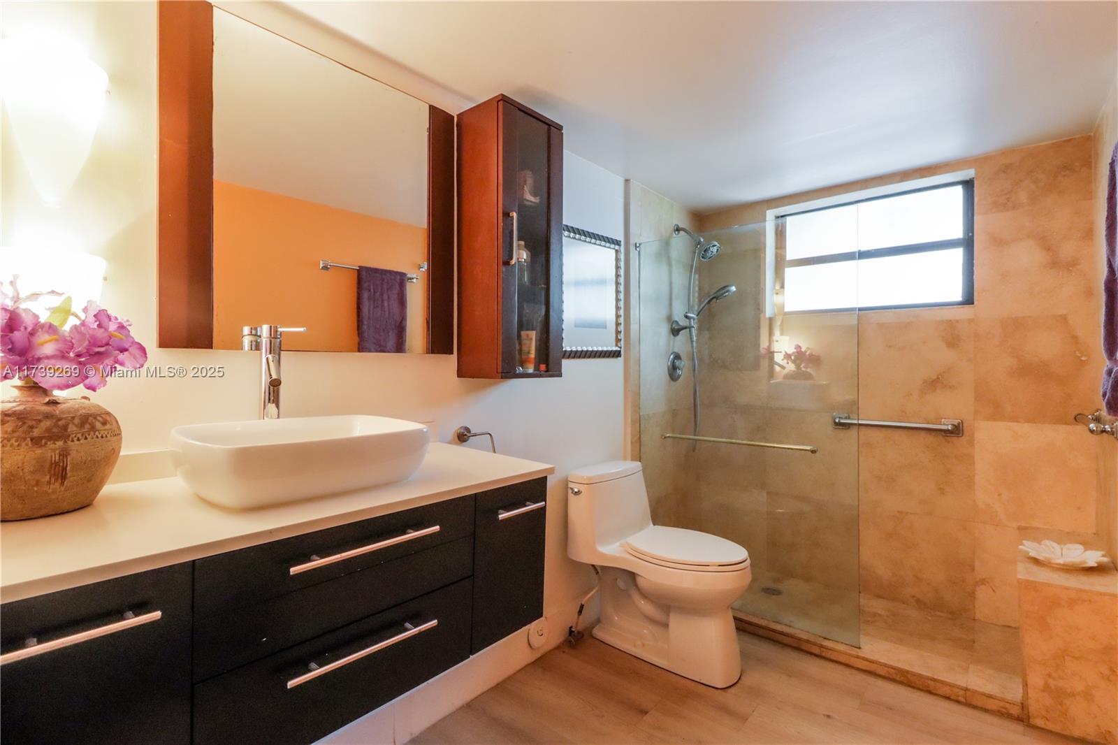 101 Ocean Ln Drive, Unit 1017 Key Biscayne, FL 33149 - Photo 18 of 25 a bathroom with a sink a toilet and shower