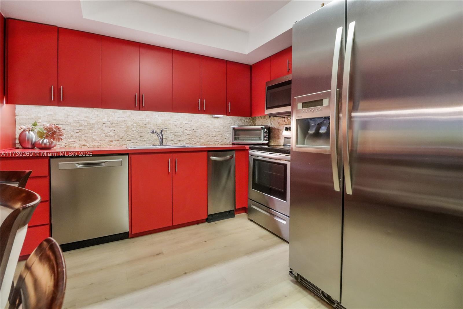 101 Ocean Ln Drive, Unit 1017 Key Biscayne, FL 33149 - Photo 9 of 25 a kitchen with stainless steel appliances granite countertop a sink and a refrigerator