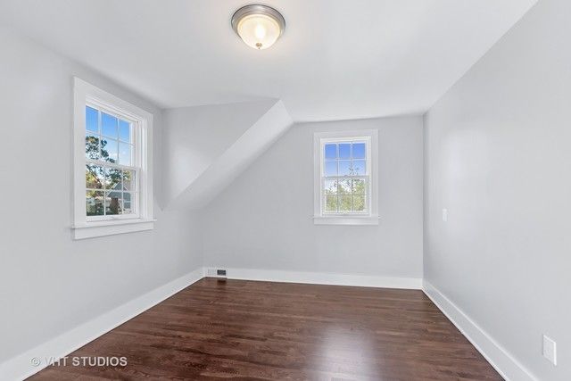 170 North Old Rand Road Lake Zurich, IL 60047 - Photo 21 of 34 an empty room with wooden floor and windows