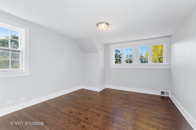 170 North Old Rand Road Lake Zurich, IL 60047 - Photo 22 of 34 a view of empty room with window and wooden floor