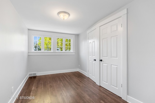 170 North Old Rand Road Lake Zurich, IL 60047 - Photo 24 of 34 an empty room with wooden floor and windows