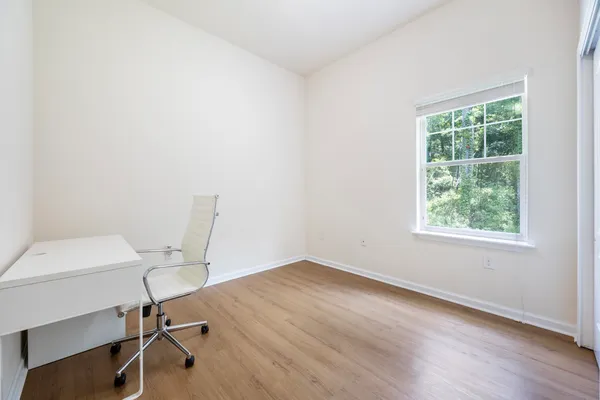 a en suite bathroom with a granite countertop sink and a mirror