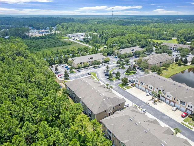 a aerial view of a house next to a yard