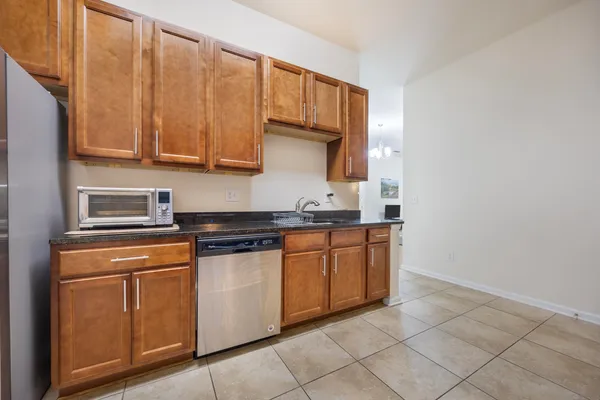 a kitchen with granite countertop cabinets and steel stainless steel appliances