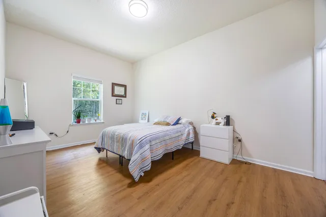a spacious bedroom with a bed and a window