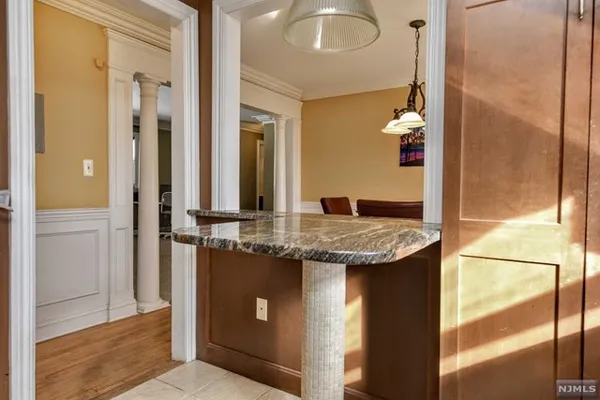view of kitchen with granite countertop cabinets and glass door