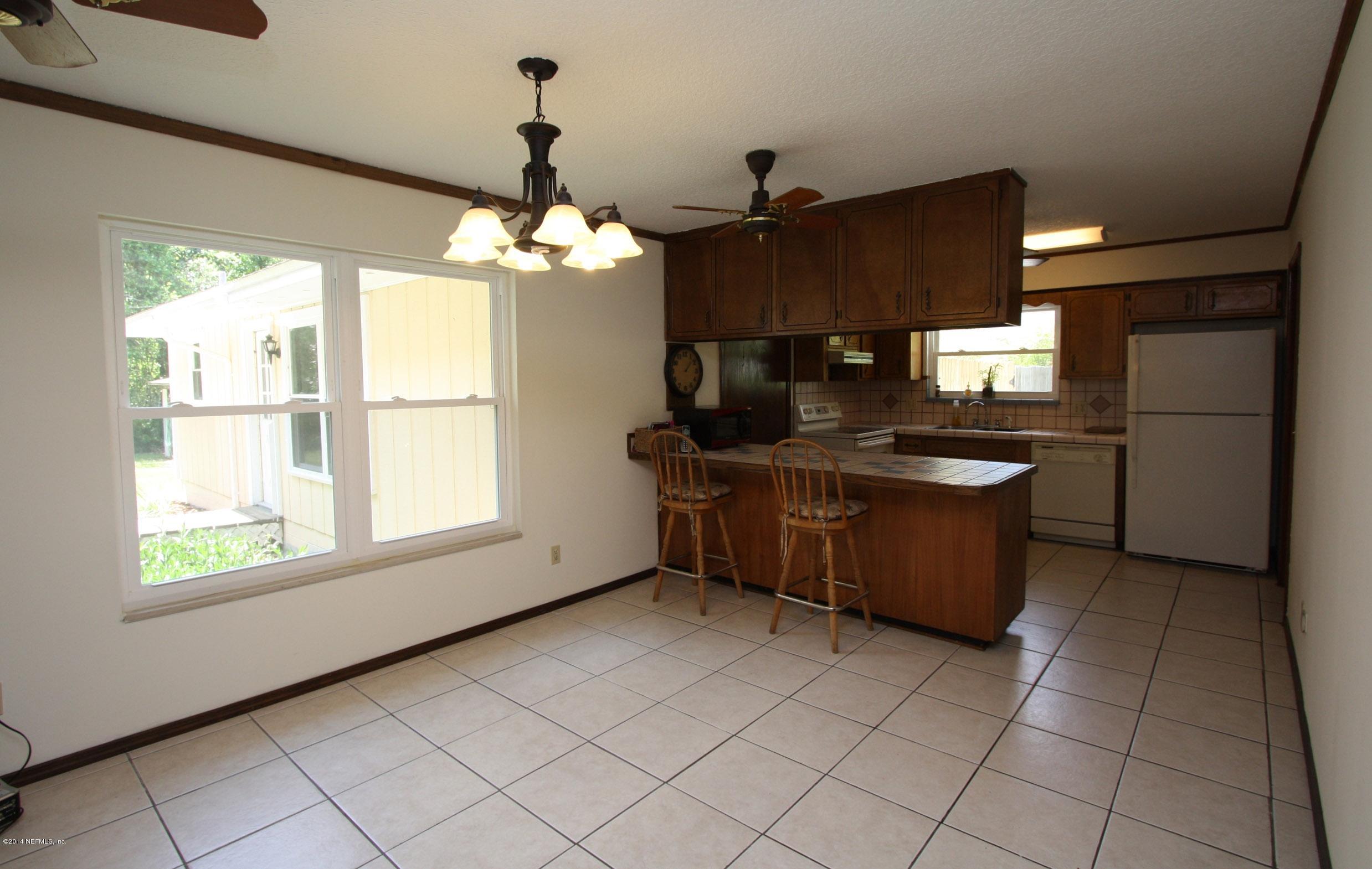 3028 Oak Road Orange Park, FL 32065 - Photo 8 of 31 a kitchen with stainless steel appliances granite countertop a sink stove and a refrigerator