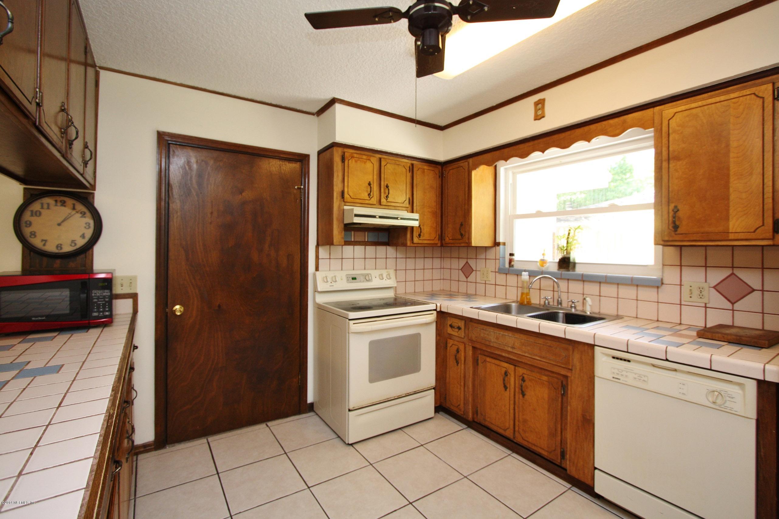 3028 Oak Road Orange Park, FL 32065 - Photo 9 of 31 a kitchen with a sink window and cabinets