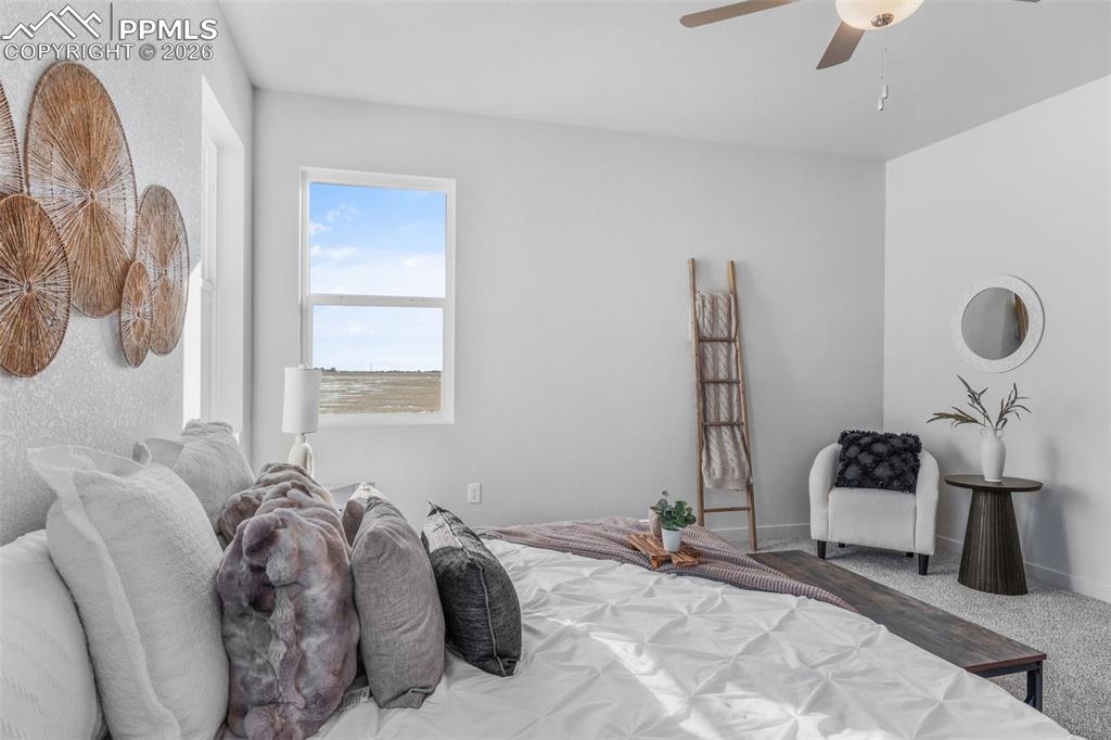 24515 Big Springs Road Calhan, CO 80808 - Photo 19 of 46 a bed room with a bed and a chair