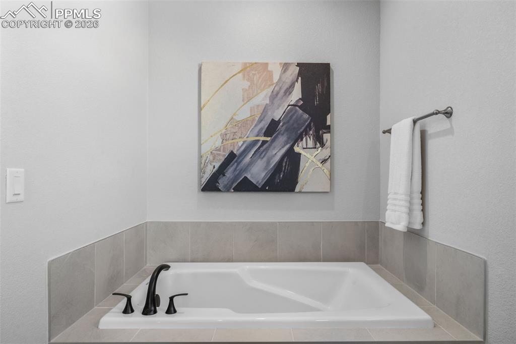 24515 Big Springs Road Calhan, CO 80808 - Photo 21 of 46 a bathroom with a bathtub and a shower