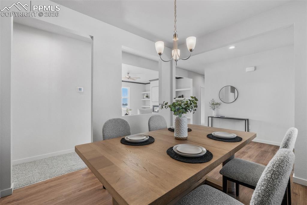 24515 Big Springs Road Calhan, CO 80808 - Photo 27 of 46 a view of a dining room with furniture and chandelier