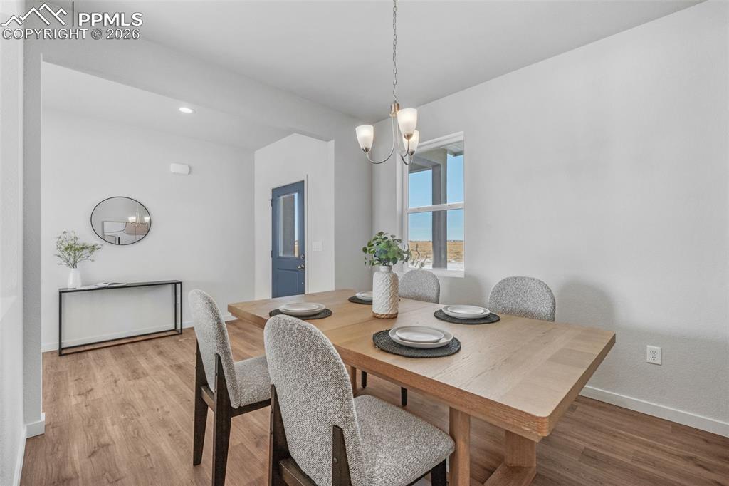 24515 Big Springs Road Calhan, CO 80808 - Photo 28 of 46 a view of a dining room with furniture and wooden floor