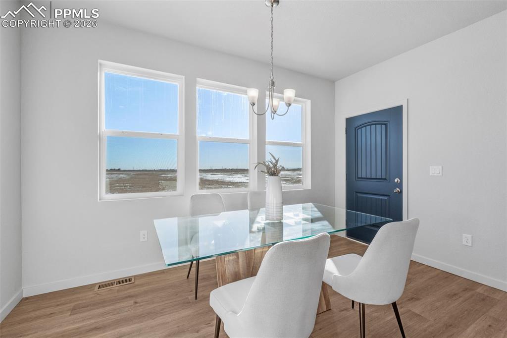 24515 Big Springs Road Calhan, CO 80808 - Photo 29 of 46 a view of a dining room with furniture wooden floor and chandelier