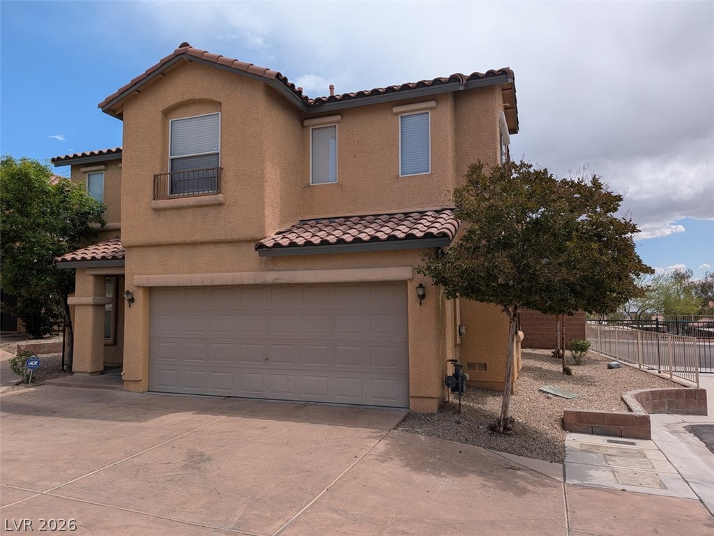 10308 Faustine Avenue Las Vegas, NV 89129 - Photo 1 of 28 A terracotta-tiled roof crowns this stucco-finished home, complete with an integrated garage and desert-friendly landscaping.