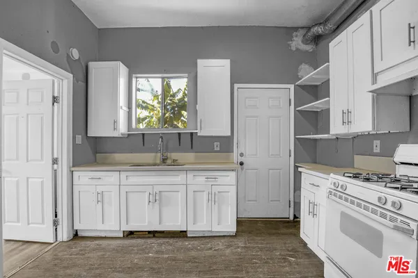 a kitchen with stainless steel appliances a stove a sink and a refrigerator