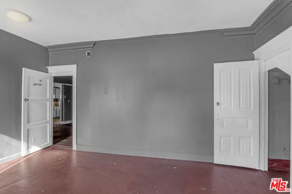 a view of an empty room with wooden floor