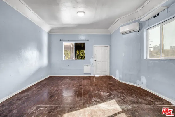 wooden floor in an empty room with a window