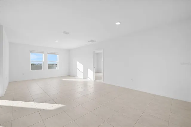a view of a kitchen with a refrigerator and a sink