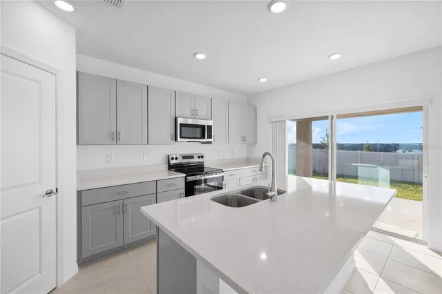 a kitchen with stainless steel appliances a refrigerator stove microwave and cabinets