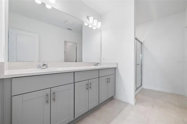 a bathroom with a glass shower door
