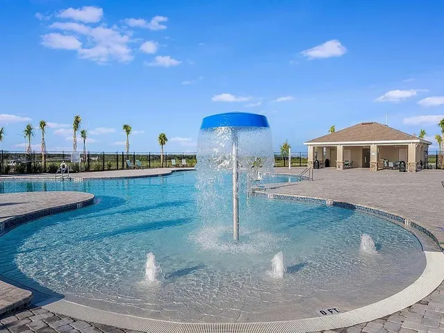 a view of a house with swimming pool and sitting area