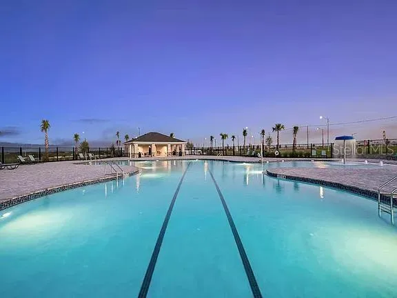 an aerial view of a house with garden space and a swimming pool
