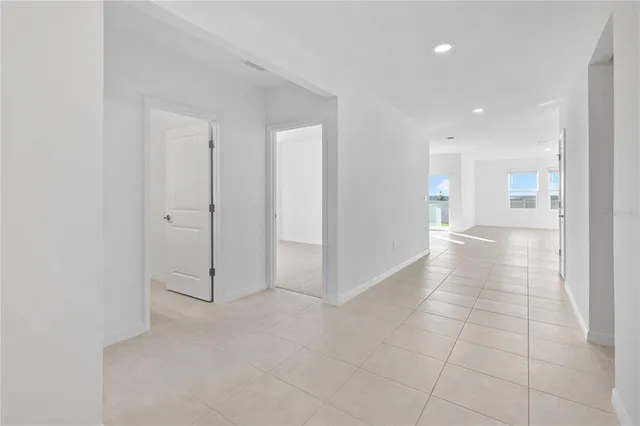 a view of a hallway with closet and a window